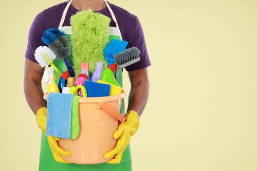 Local cleaner making a bed and refreshing a rental property in Swiss Cottage